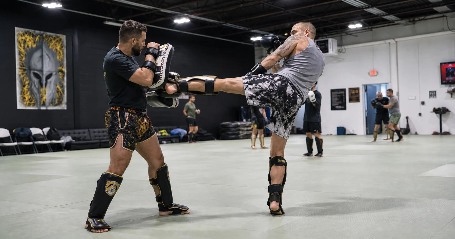 Kickboxing partners practicing a controlled pad drill